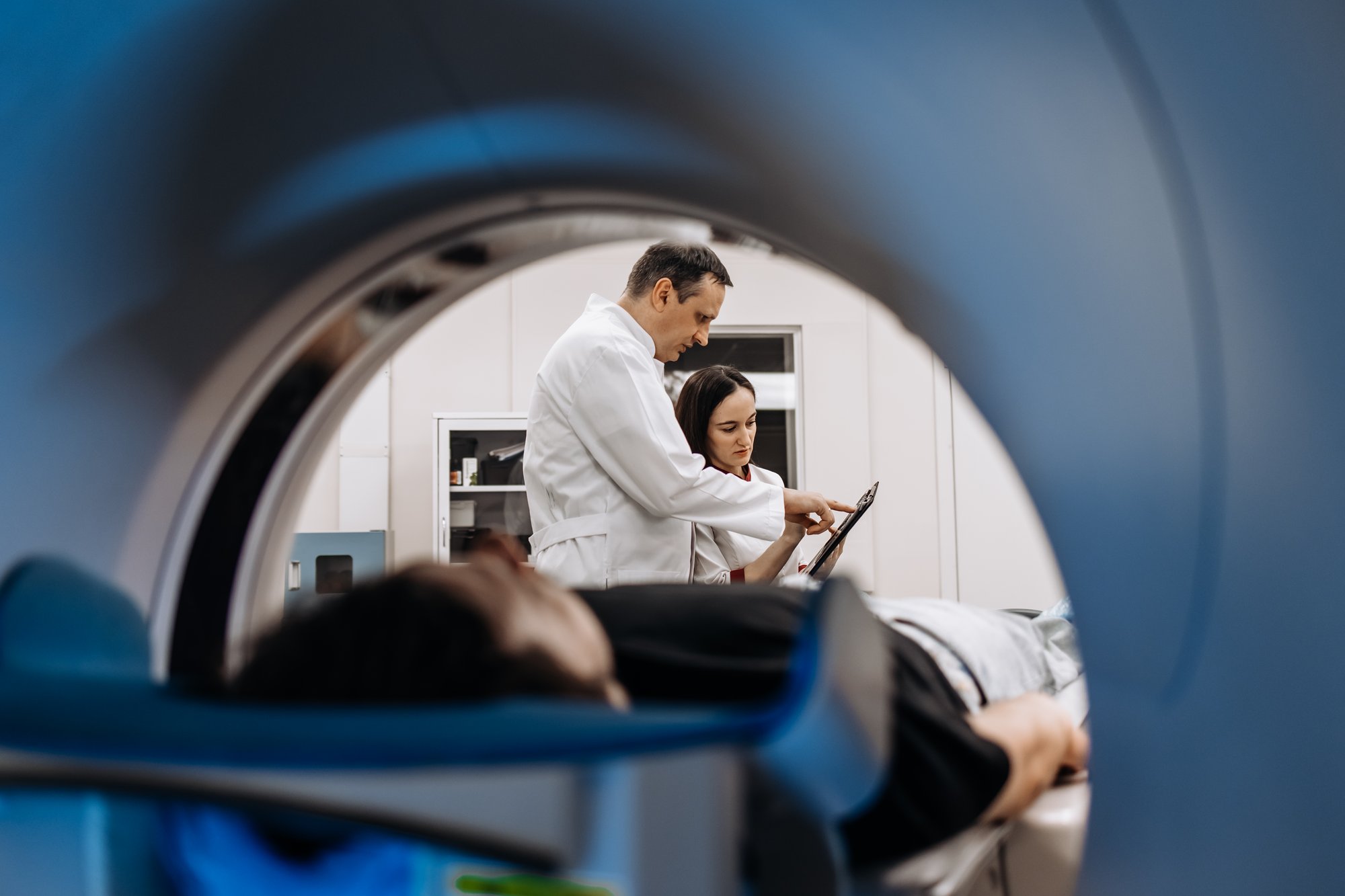 In a bright diagnostic center, a young man undergoes a CT or MRI scan In a bright diagnostic center, a young man undergoes a CT or MRI scan